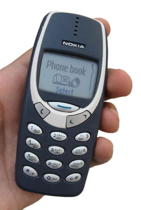 A Nokia 3310 held in one hand