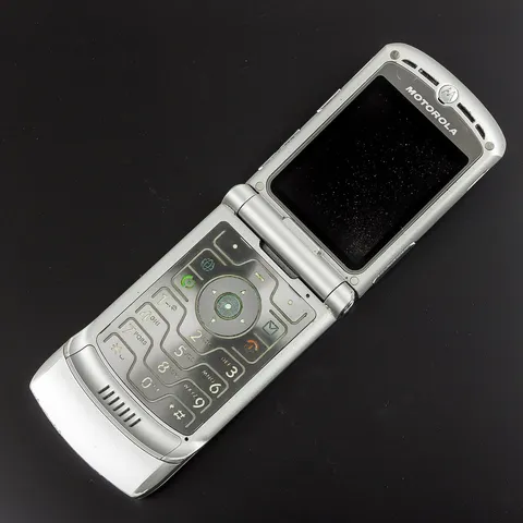 A silver Motorola RAZR V3, open, showing the keypad
