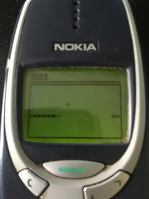 Snake being played on a Nokia 3310 screen